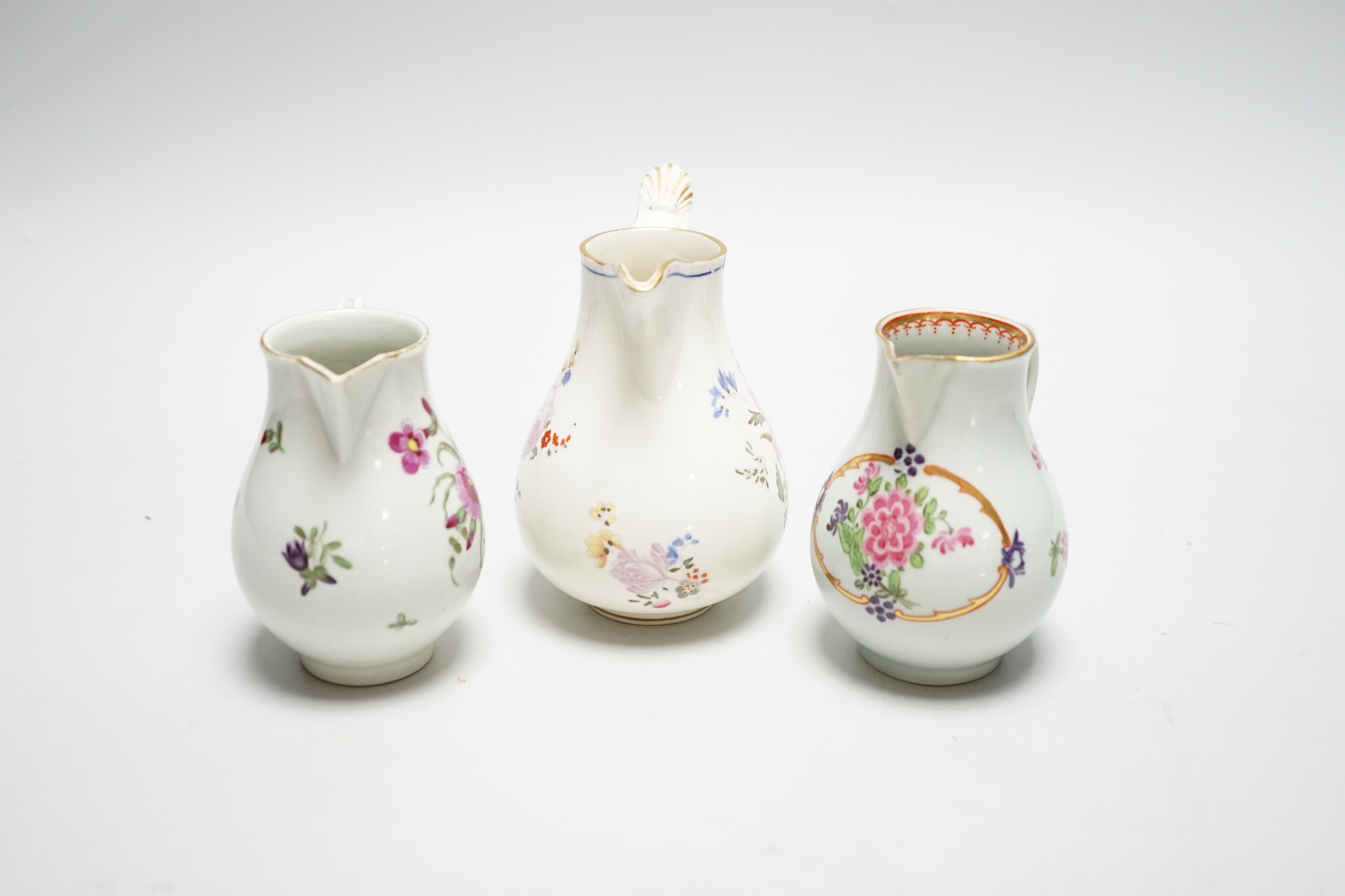 Two Worcester flower painted sparrow-beak jugs, c.1780 and an English porcelain milk jug, c.1825 (3)